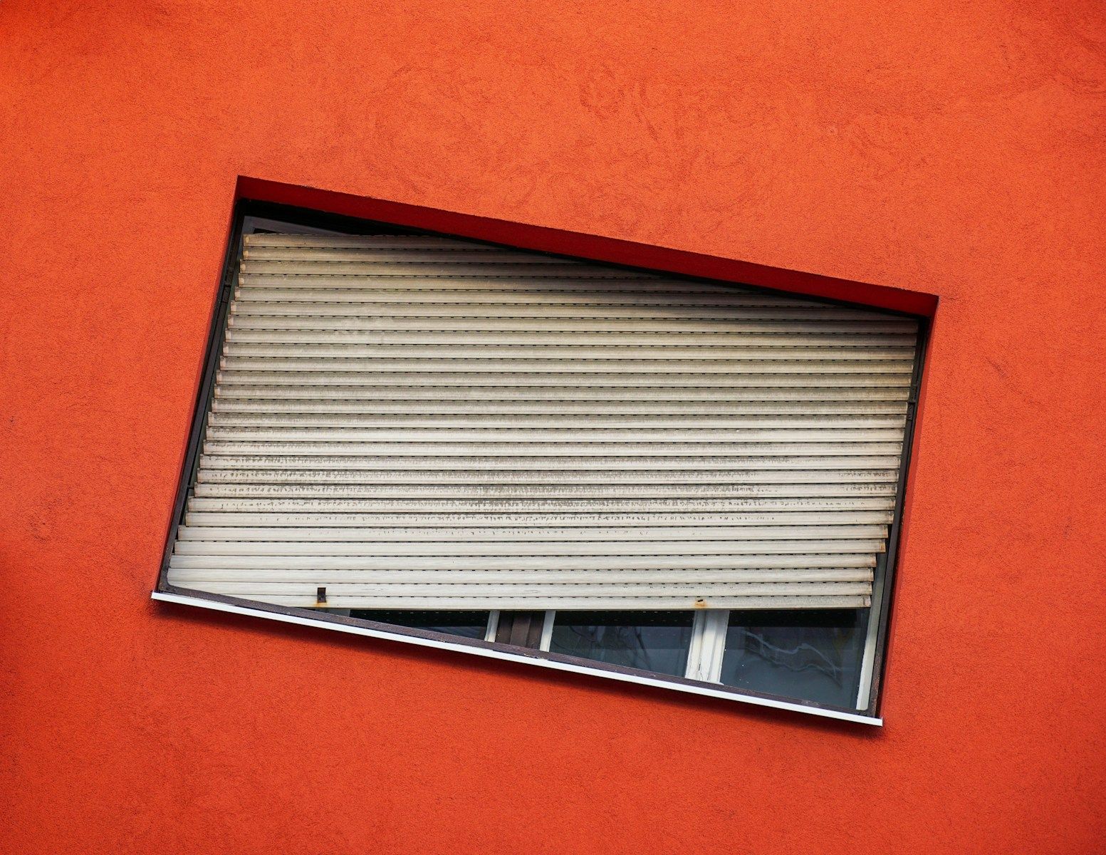 gray Venetian blind hanging on a window